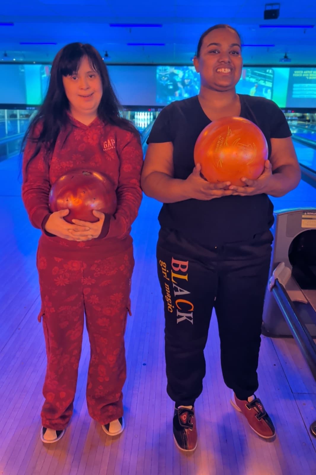 Two members of the Haley family enjoying a day out bowling together.